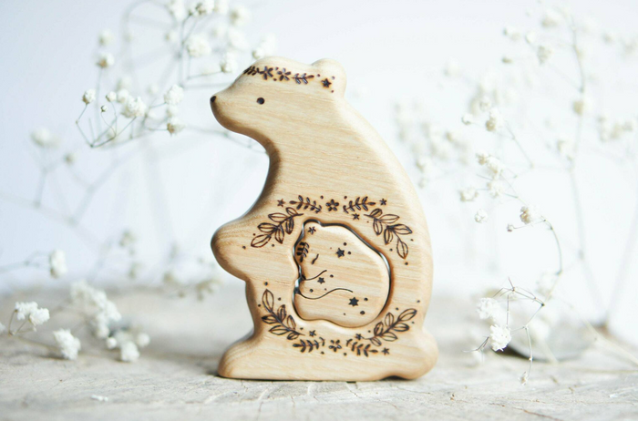Hand-carved wooden bear pregnancy announcement puzzle with a baby tucked inside the belly, by Tiny Fox Hole